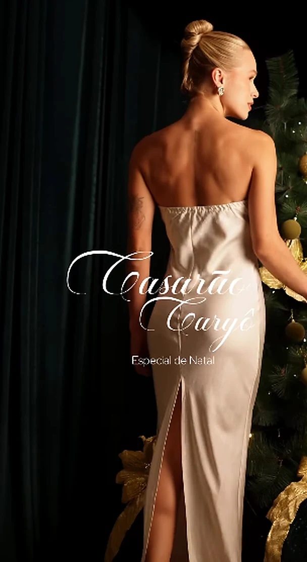 Editorial de Natal do Casarão: modelo de vestido acetinado claro junto ao cenário verde e dourado